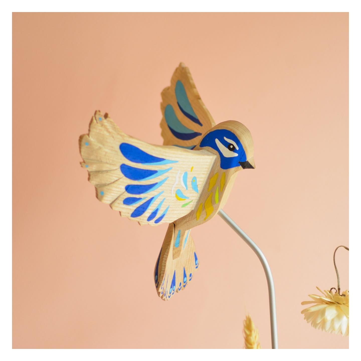 Handcrafted bird sculpture with colorful details by La Petite Hirondelle