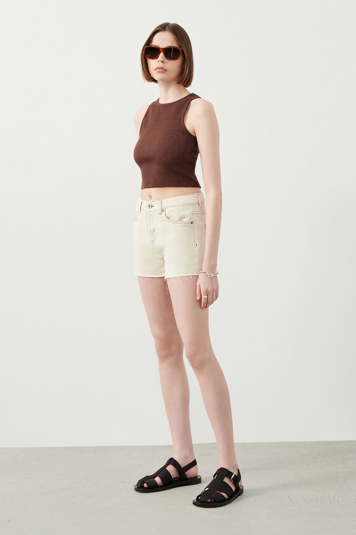 Stylish Look created with Ecru Denim Shorts, black sandals and cool sunglasses for a great summer outfit