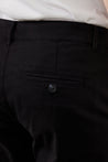 Zoomed-in texture shot of black chinos for men, showcasing the high-quality cotton fabric blend.