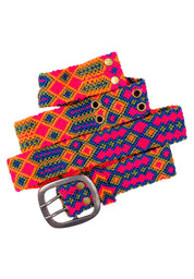 Close-up view of the intricate geometric patterns on the Adriana Festival Belt in neon pink and  blue.