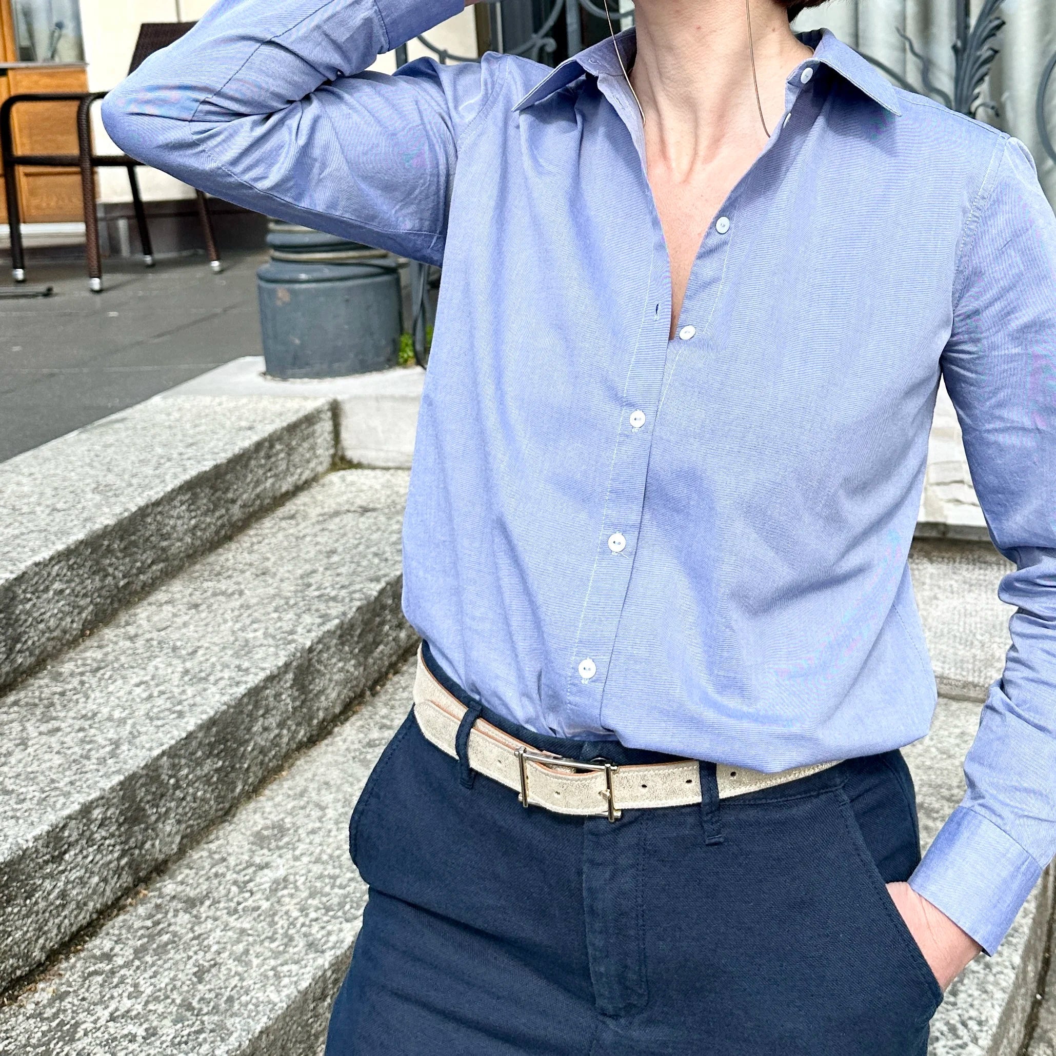 Woman wearing a sky blue classic cotton shirt to the office.