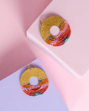 Close-up of Mayana Designs Lilac Circle Fringe Earrings, showcasing the intricate beadwork and hammered brass arch