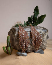 Mayana Designs Beaded Handwoven Taos Fringe Earrings in Light Brown on display. Highlighting the intricate beadwork and fringe design