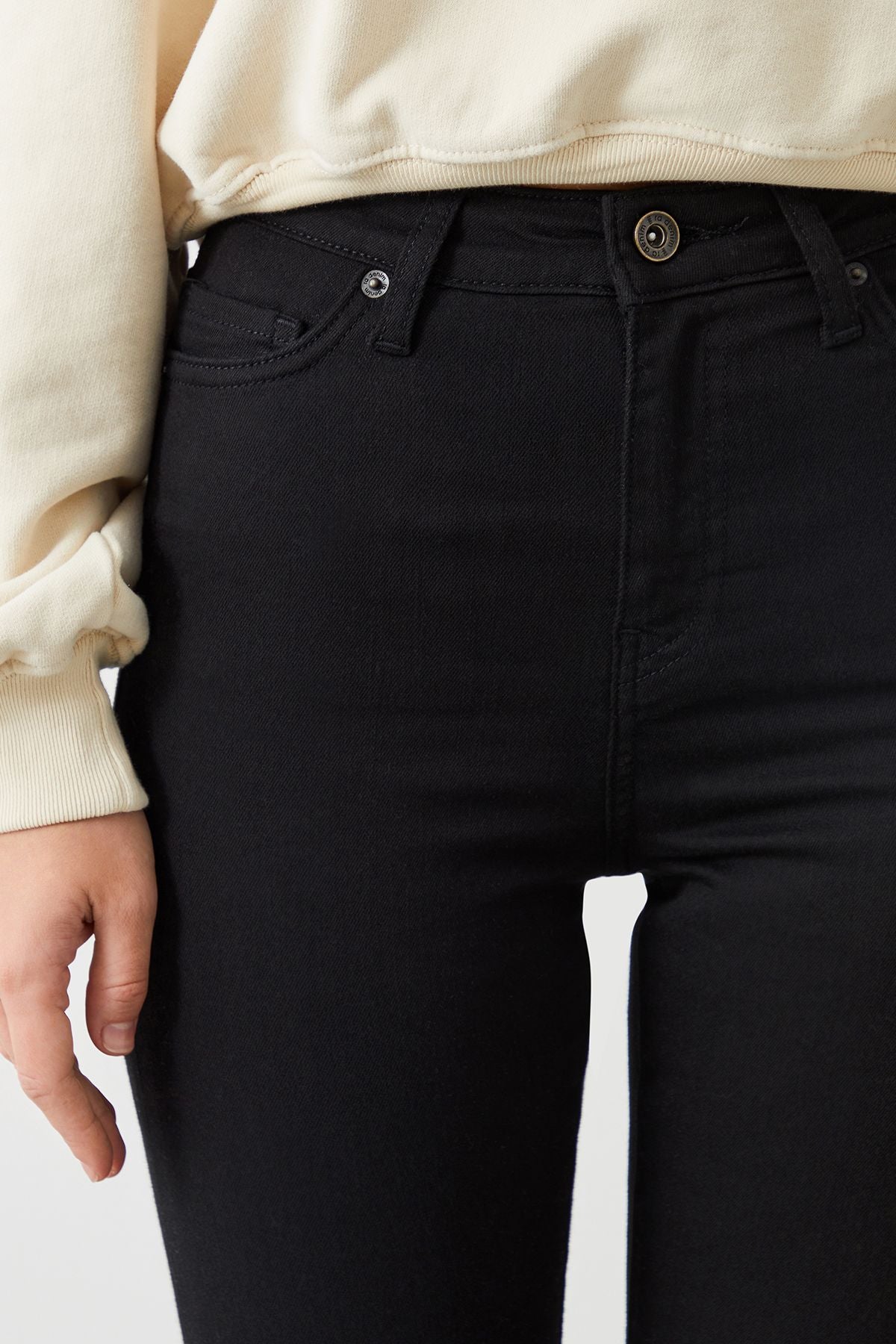 a close up of a person wearing black jeans