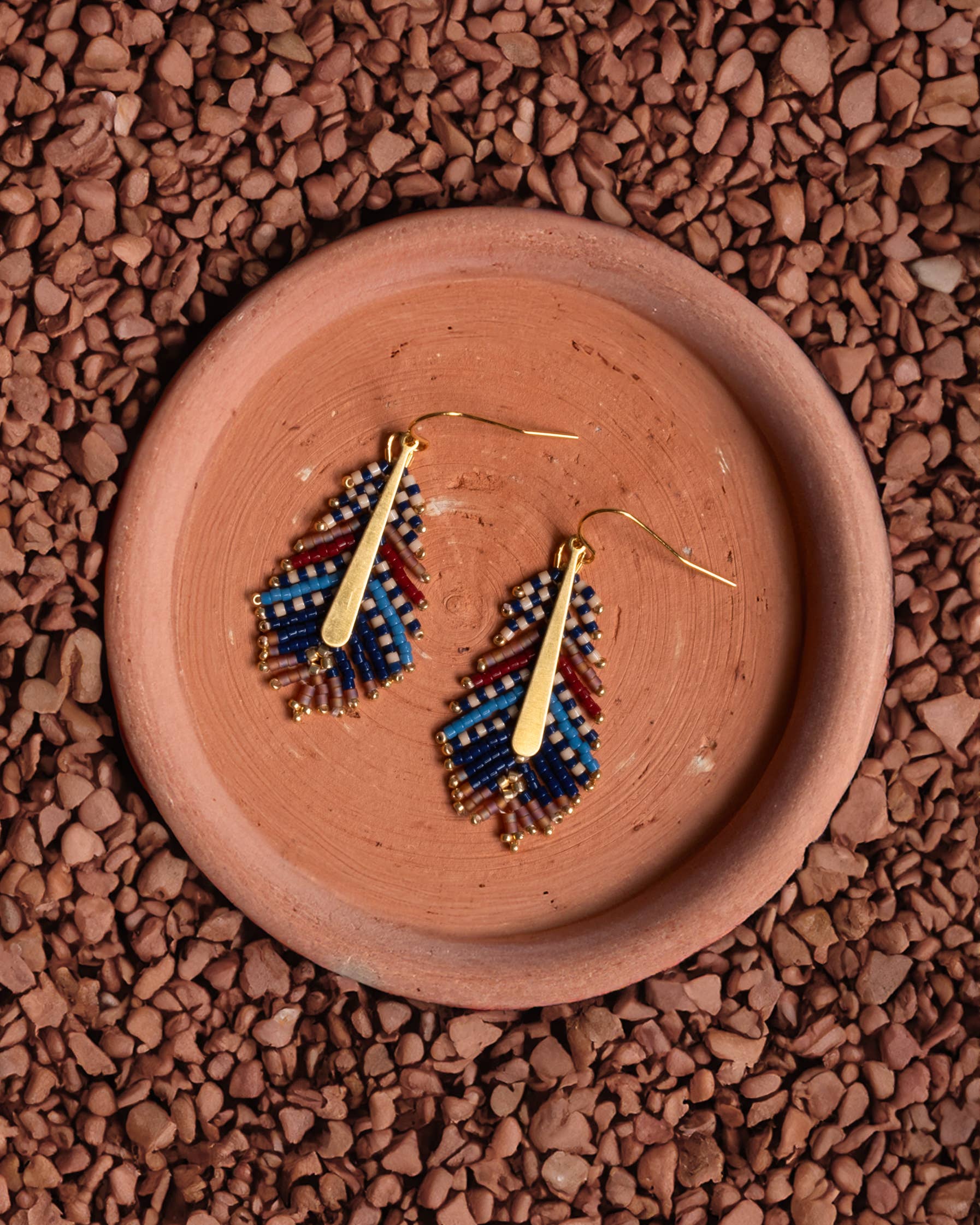 Ethically handcrafted blue and brown Miyuki beaded earrings in a delicate feather design by Mayana Designs