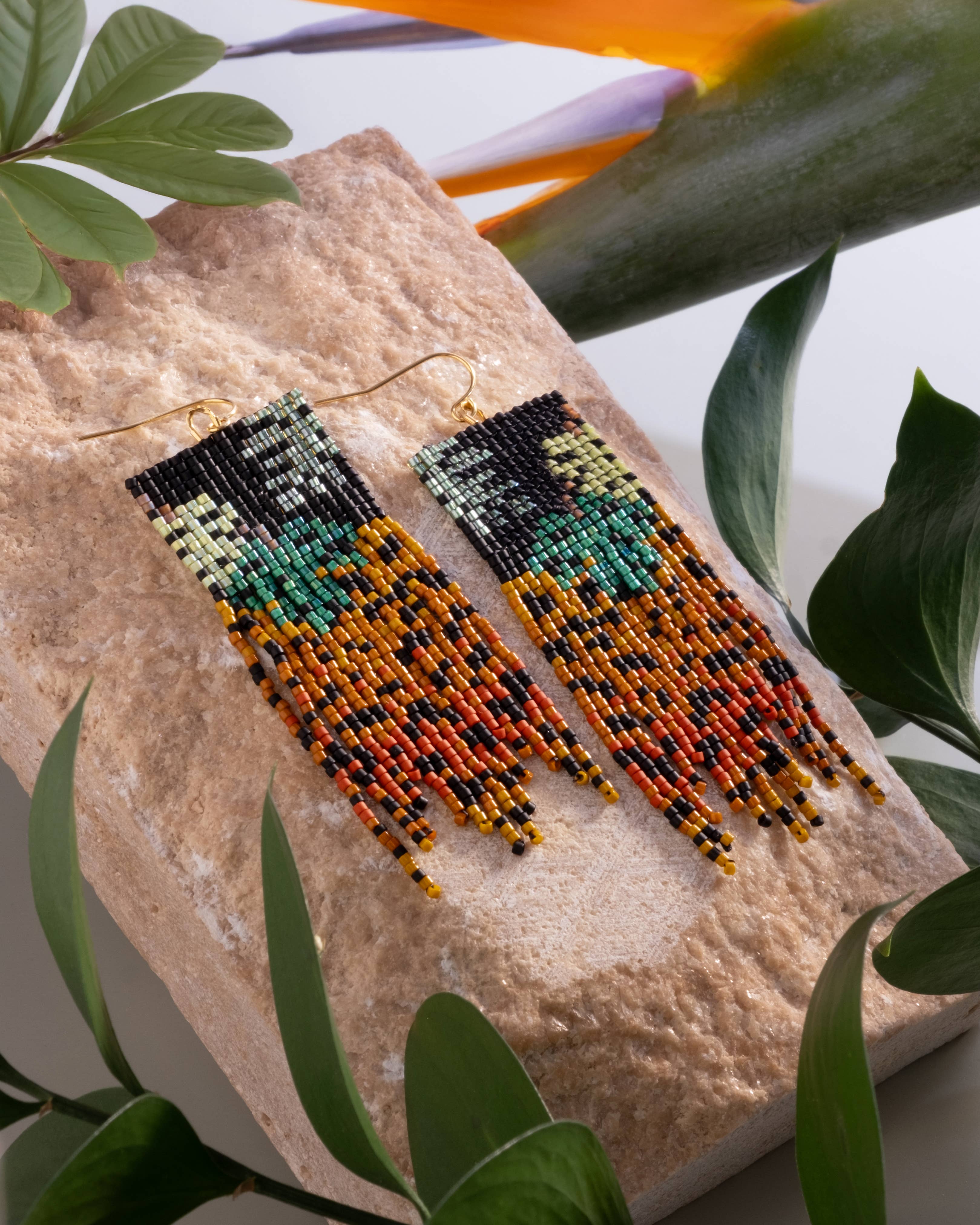 Close-up of Mayana Designs Beaded Handwoven Jaguar Fringe Earrings, highlighting the intricate beadwork and vibrant colors