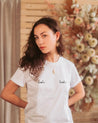 Stylish women's white organic cotton T-shirt with hand-embroidered text 'Boobs'.