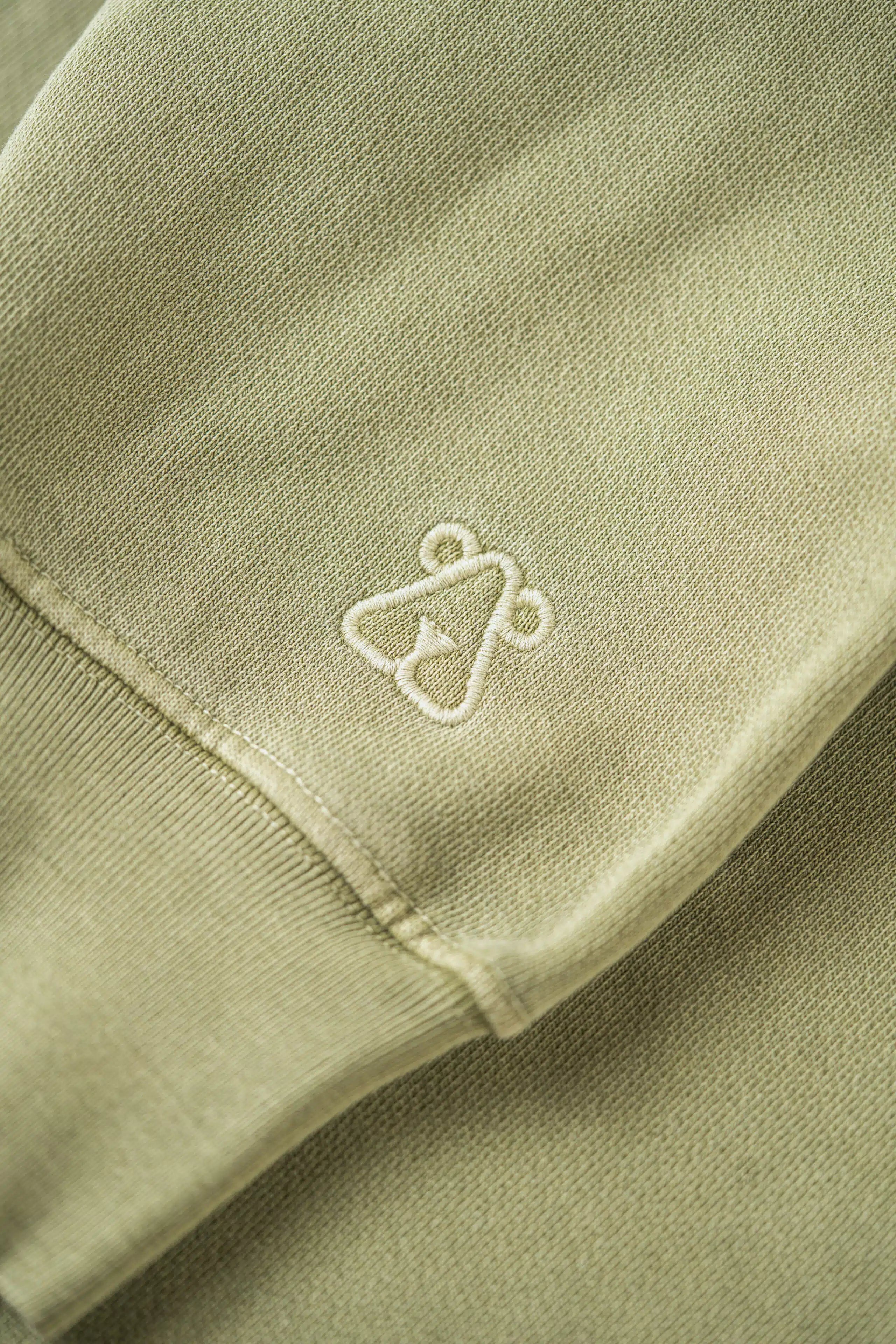 Close up of the green naturally dyed organic cotton-jersey used by French Brand Doxa for their sustainable Hoodies.
