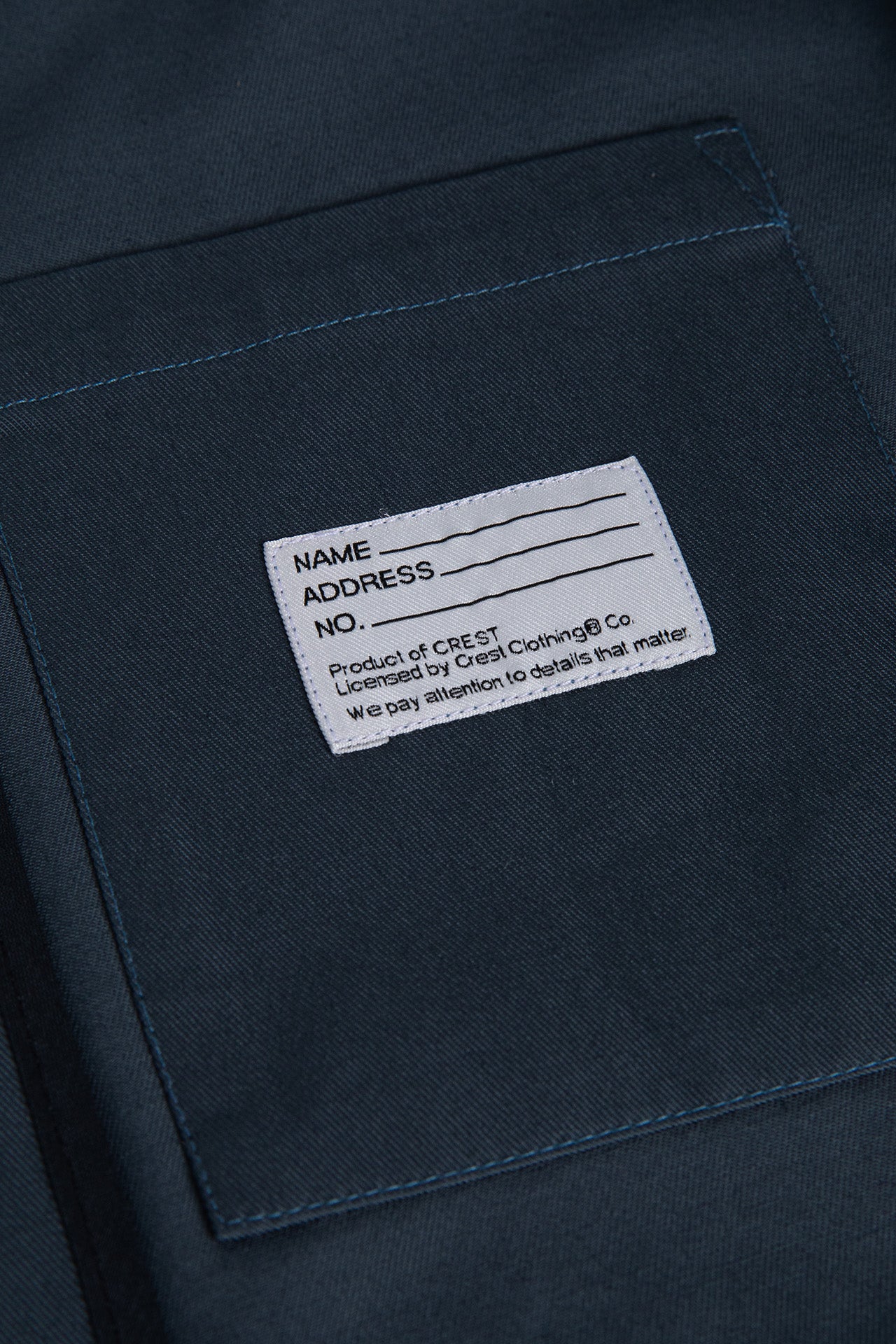 Close-up of inside pocket of the Patch Men's Jacket featuring name patch.