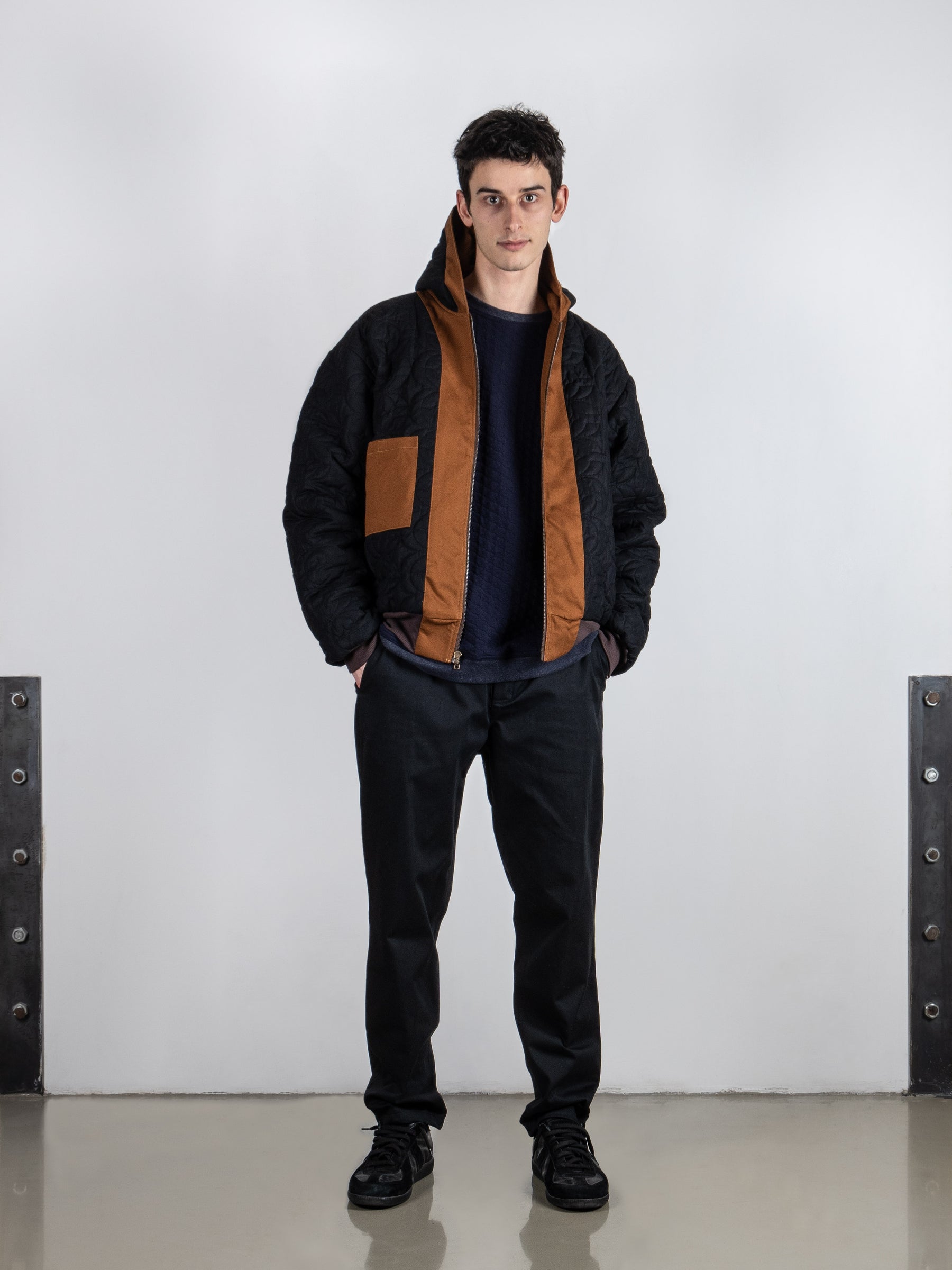 Unique Rust Hooded Duck Jacket with reversible design, showcasing quilted black lining as outer fabric for a distinct style twist.