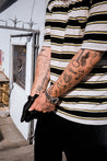 Male model with tatoos wearing CREST Border Short Sleeves T-Shirt in Black - Front View