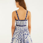 Full body view of a model styling the off-white Farm Rio Porcelain Garden mini dress