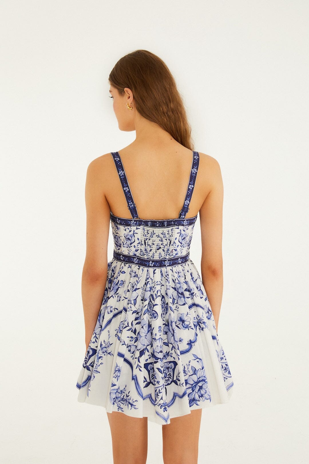 Full body view of a model styling the off-white Farm Rio Porcelain Garden mini dress