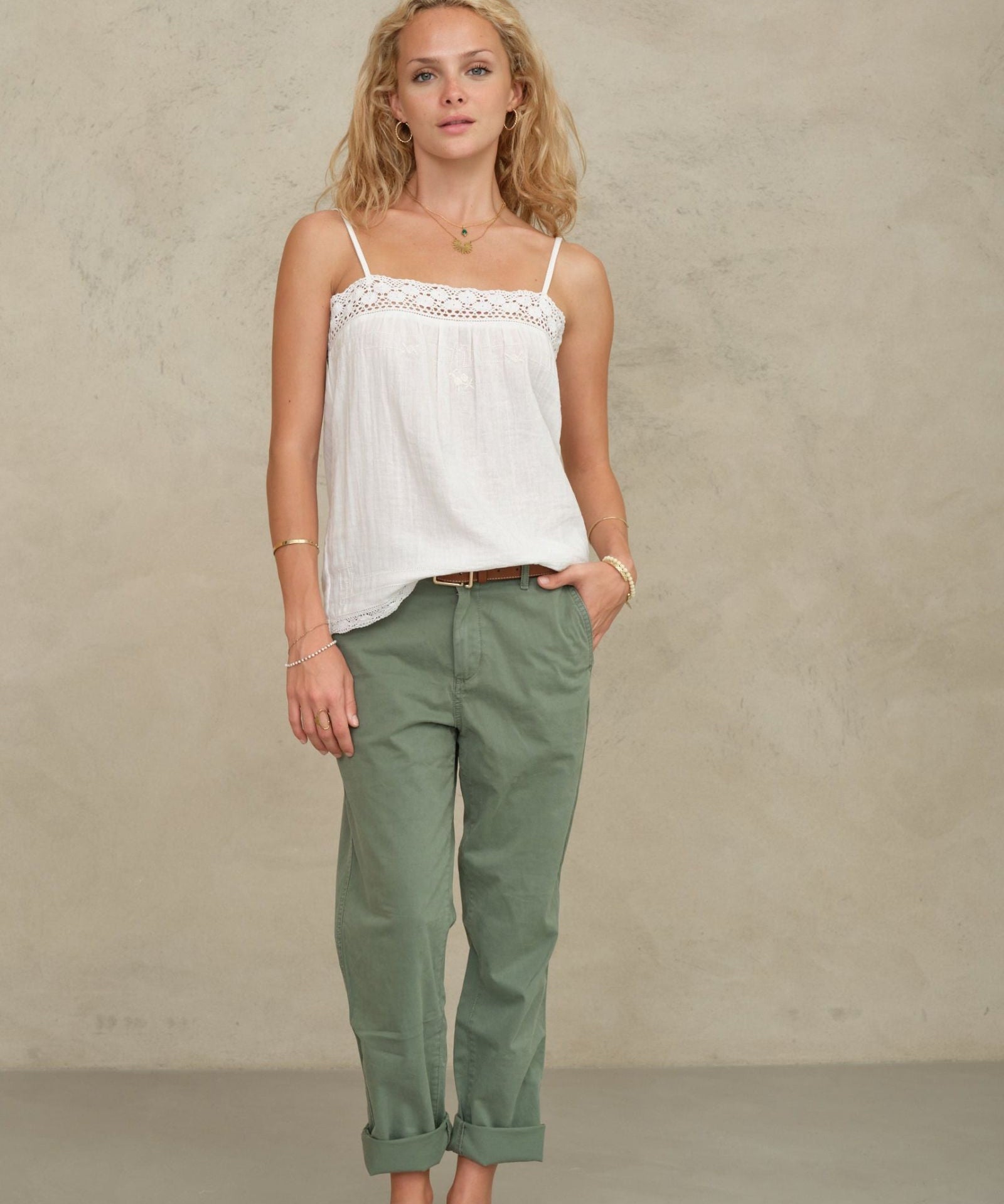 Front view of a model posing in a white bohemian-style cotton camisole from Mabe Apparel.