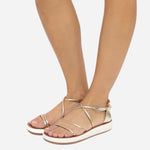 Ancient Greek Sandals Anastasia Comfort sandals in platinum worn on foot, showing the slim metallic crossover straps and cushioned cream sole