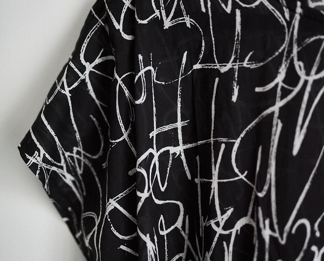 Close-Up of Unique Hand-Written Text on Dress