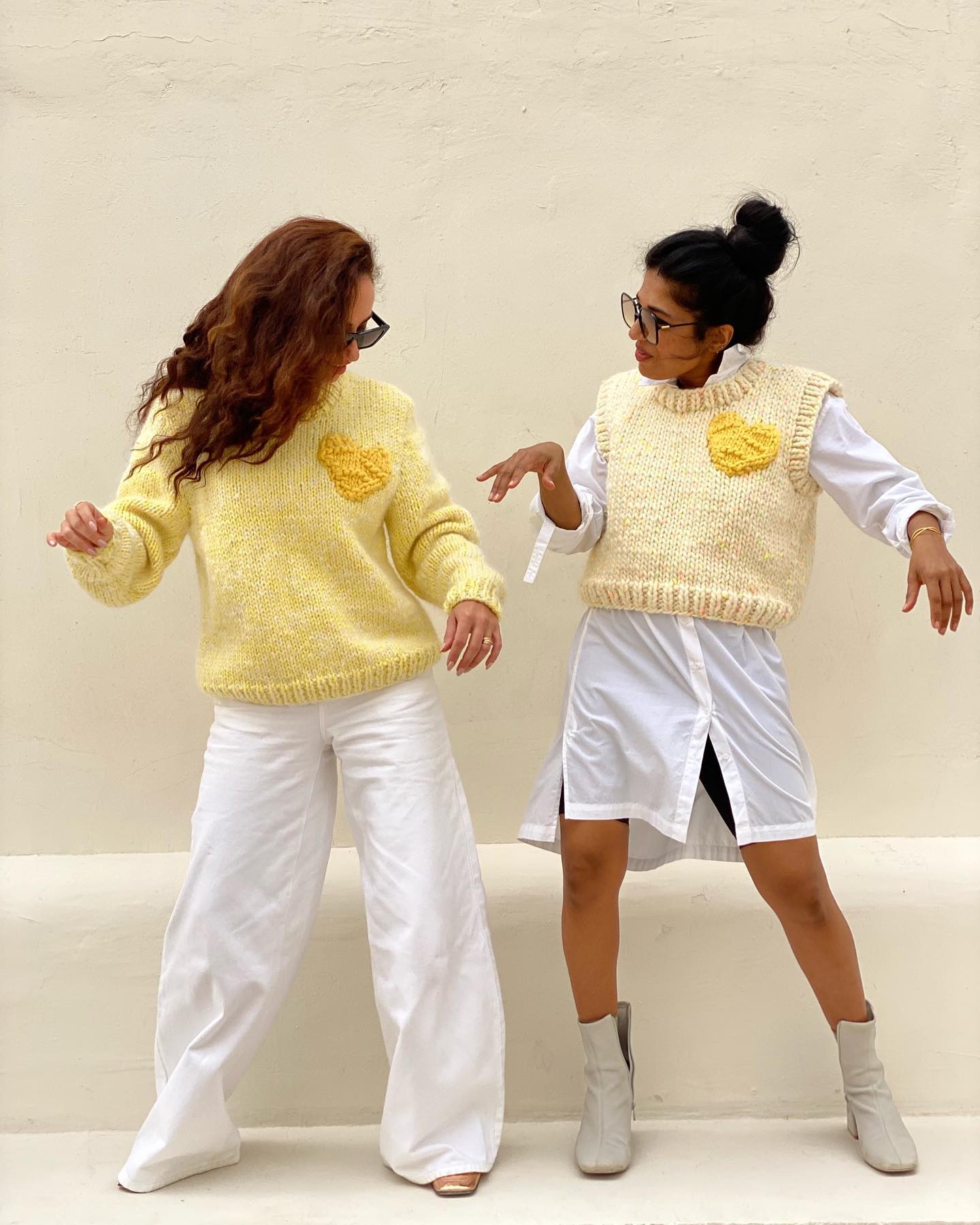 Women wearing sft yellow knit pullover with a yellow heart detail, ethically crafted by Atelier 8/02