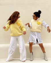 Women wearing sft yellow knit pullover with a yellow heart detail, ethically crafted by Atelier 8/02