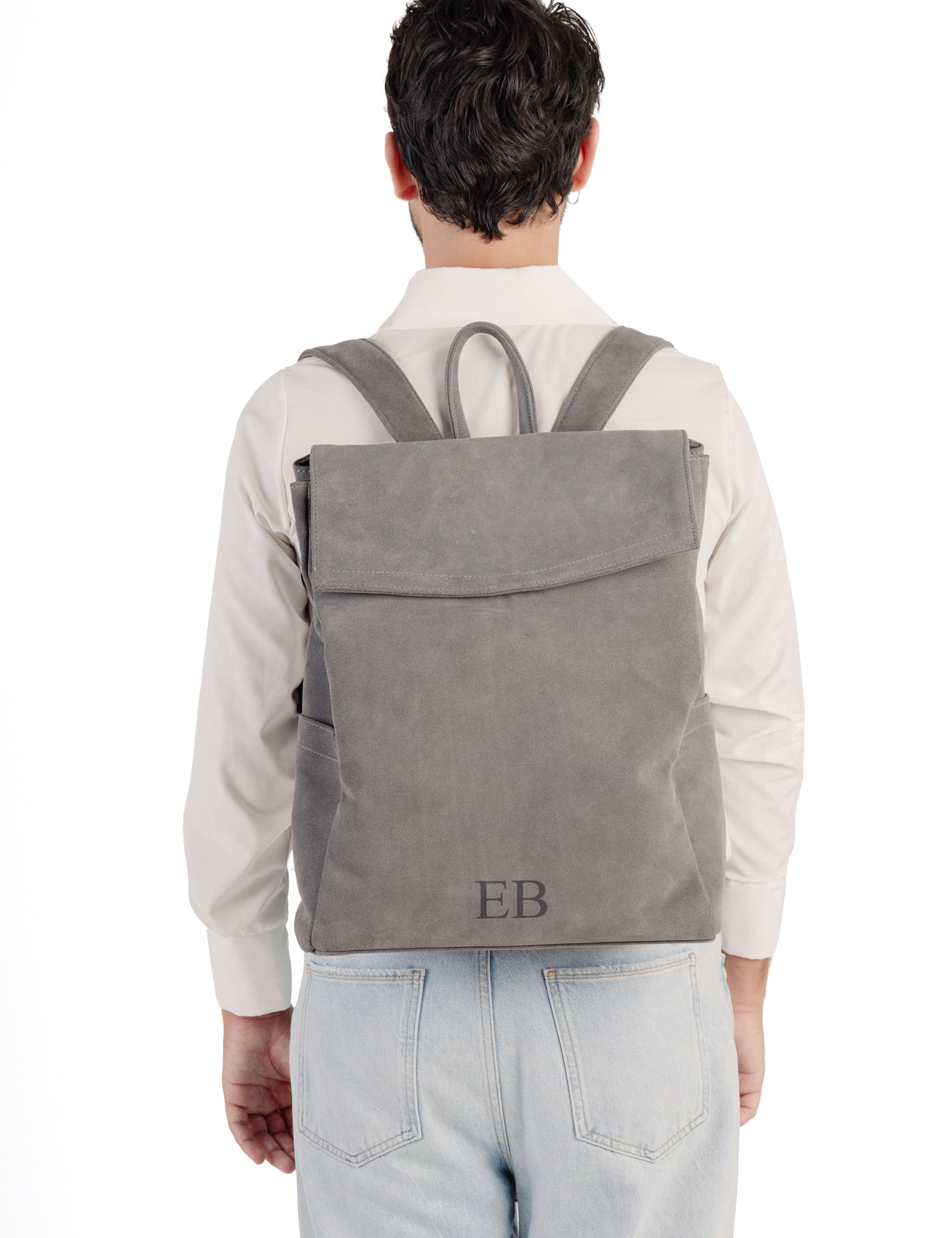 Young Man wearing the Emmy Boo Grey Suede Backpack Lipari  with adjustable shoulder straps.