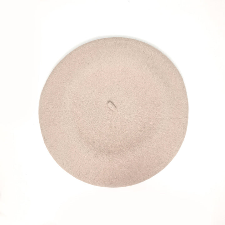 A stylish ecru beret, exuding elegance and warmth with its classic color and luxurious texture