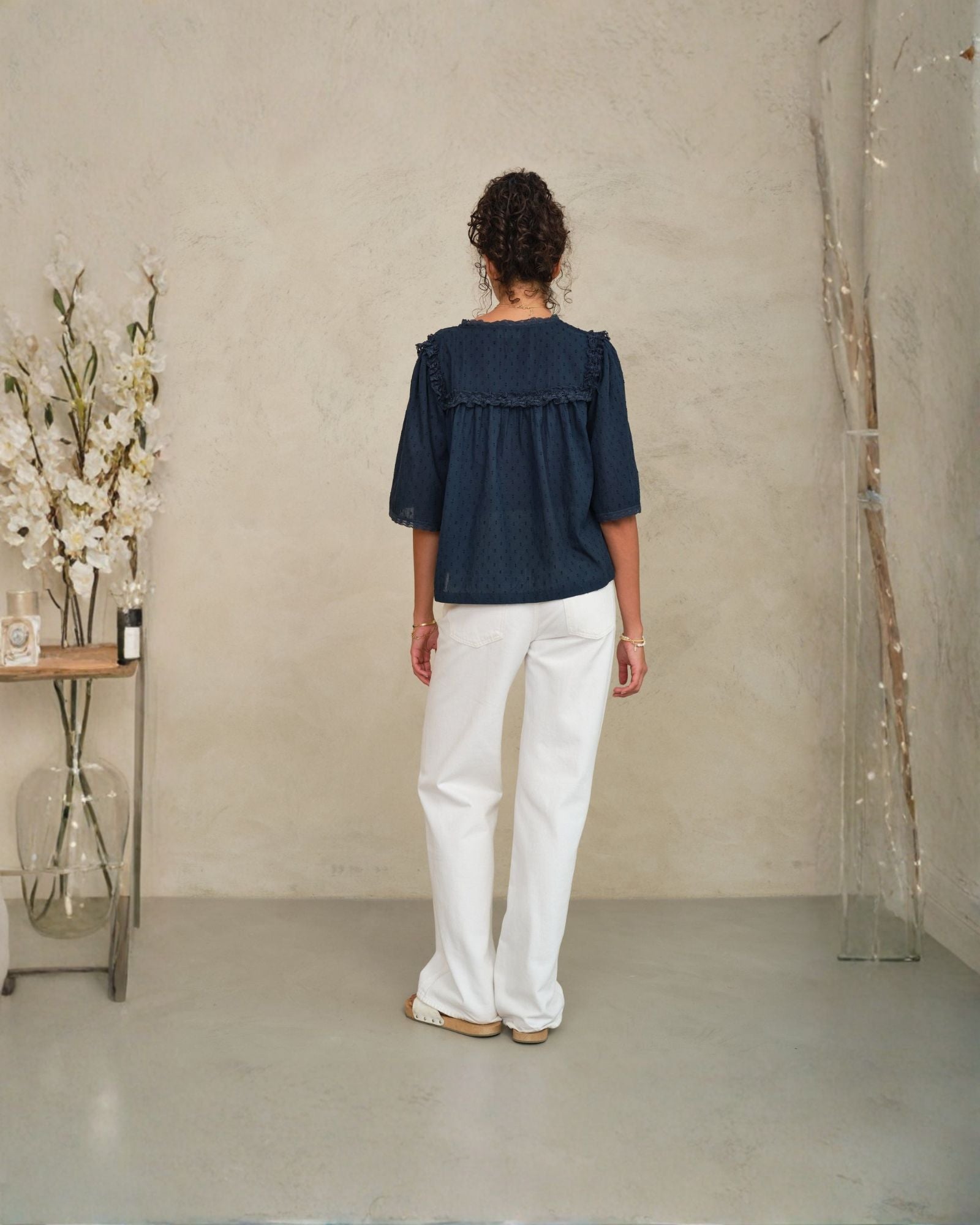 Back view of Frill Detail Top in Navy showing relaxed fit on model