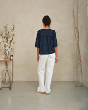 Back view of Frill Detail Top in Navy showing relaxed fit on model