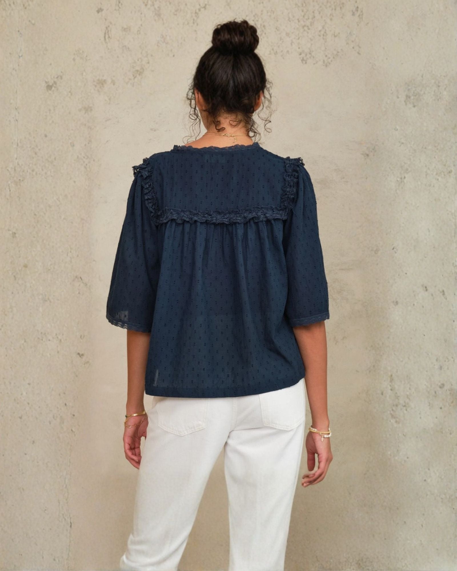 Back view of Frill Detail Top in Navy showing relaxed fit on jean