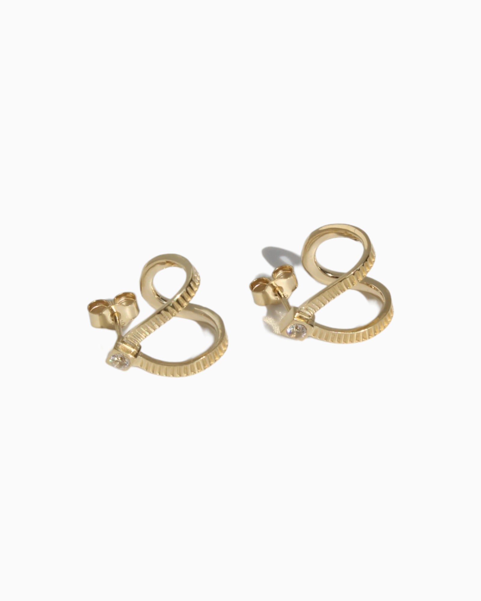 Handmade Calliophis gold earrings with transparent zircon