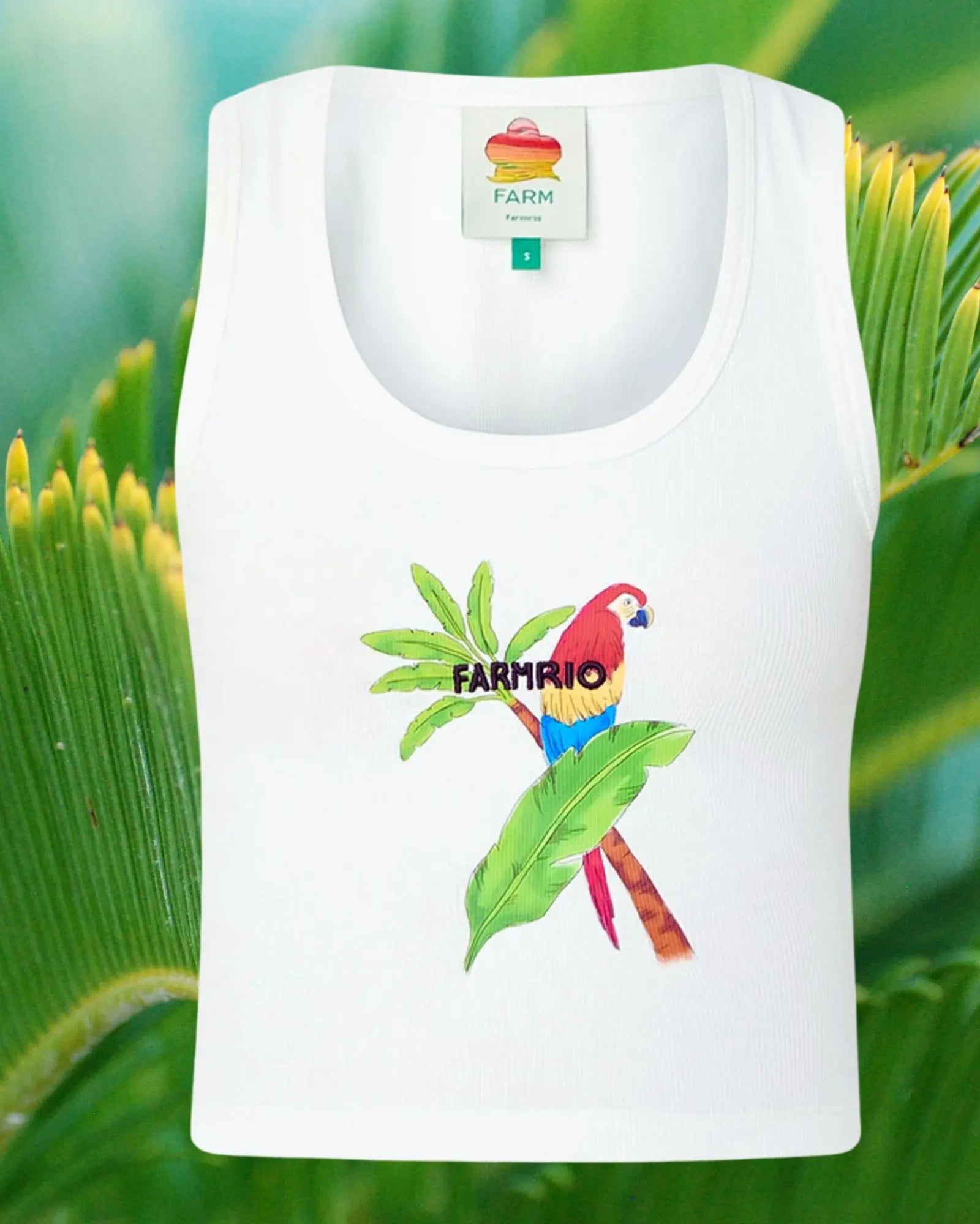 White tank top with a parrot design and 'Farm Rio' branding on a green leaf background