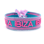 Close-up of adjustable turquoise woven friendship bracelet with pink border and embroidered "IBIZA IBIZA IBIZA" lettering with sliding knot cords.