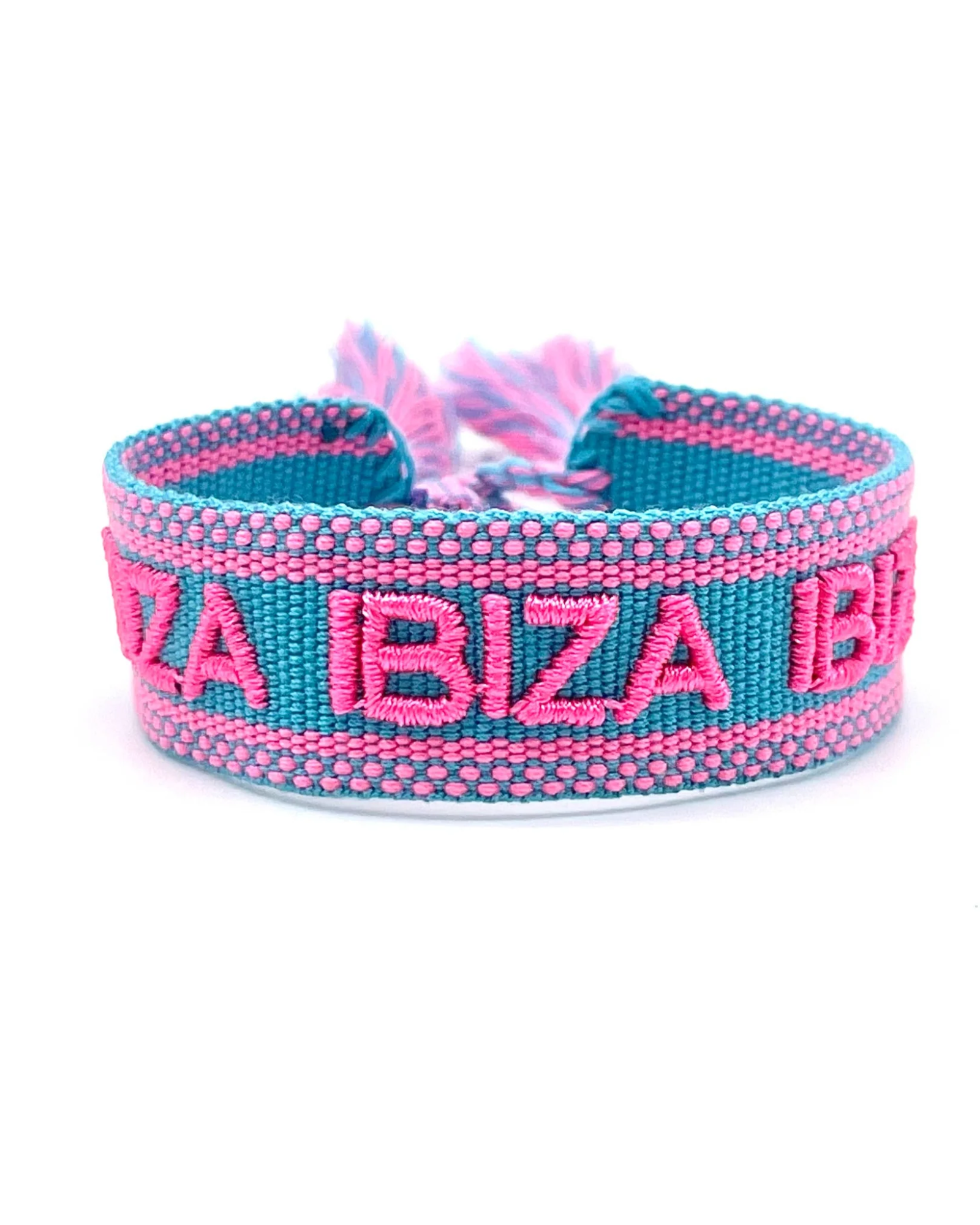 Close-up of adjustable turquoise woven friendship bracelet with pink border and embroidered "IBIZA IBIZA IBIZA" lettering with sliding knot cords.