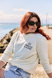 Woman wearing the Victoire Ecru Sweatshirt with a stylish pair of jeans and minimalistic accessories.