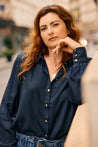 Stylish woman wearing a dark blue Tencel blouse by KS Vestiaire Intemporel
