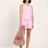 Model wearing LANIUS pink linen tank top with matching pink linen shorts