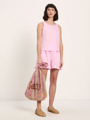 Model wearing LANIUS pink linen tank top with matching pink linen shorts
