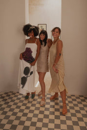 Three women wearing Chetumal huaraches in different colors, showcasing the versatile style and comfort of the sandals. 