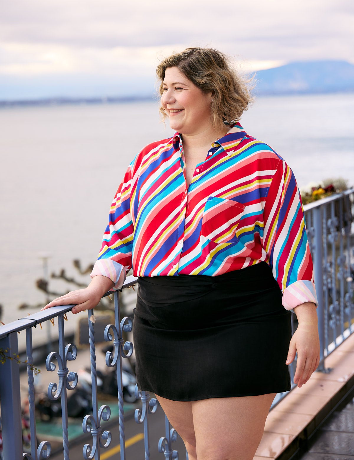 Plus Size Woman wearing Aloha shirt  with vibrant multicolor stripes
