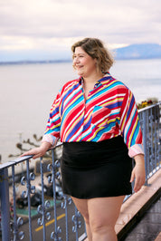 Plus Size Woman wearing Aloha shirt  with vibrant multicolor stripes