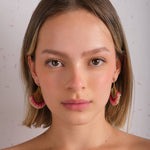 Woman wearing Mayana Designs Beaded Handwoven Flamenco Fan Earrings in Pink