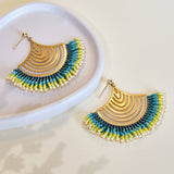 Close-up of Mayana Designs’ Beaded Handwoven Flamenco Fan Earrings in Aqua, showcasing ruffled Miyuki glass beads and brass components.