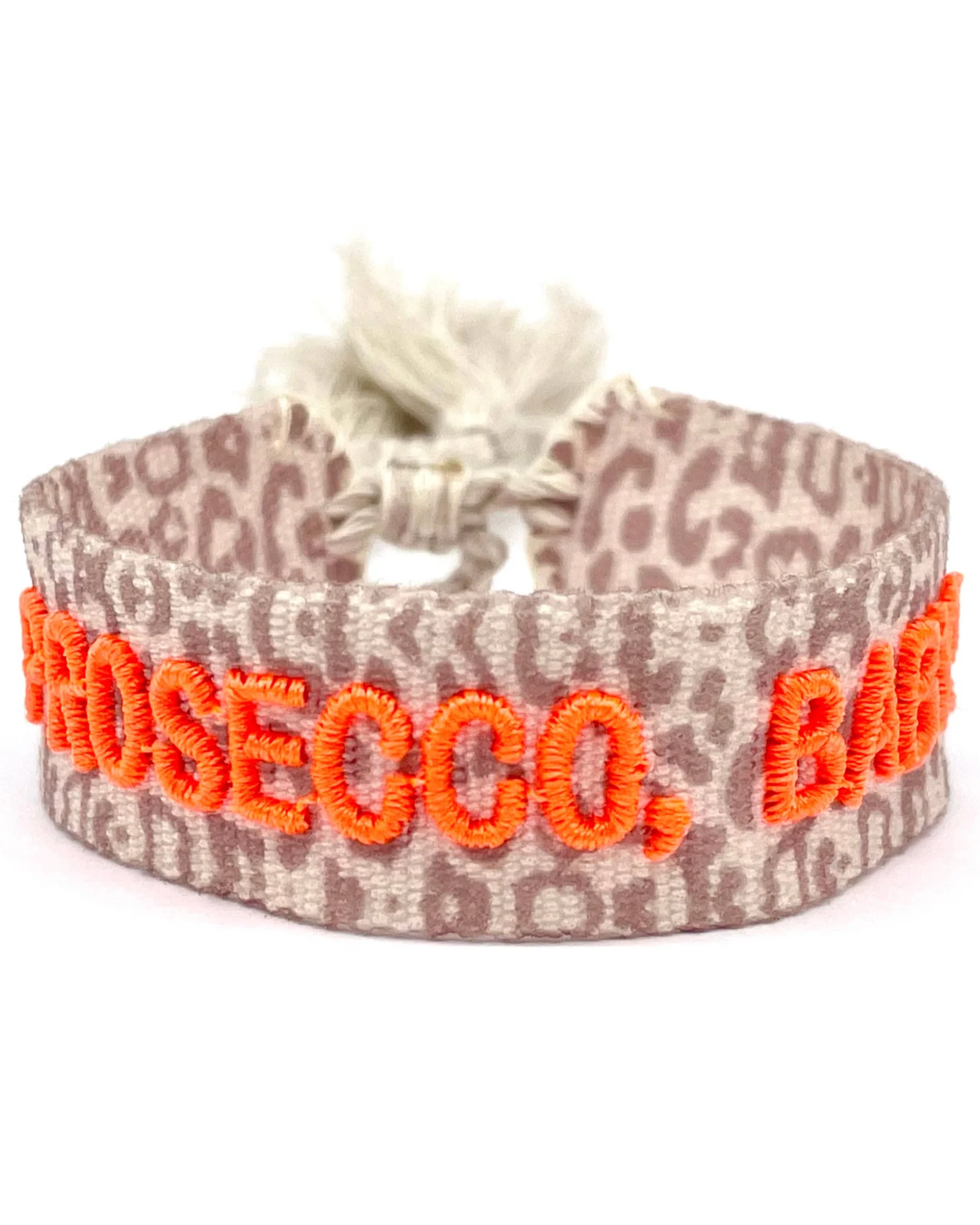 Close-up of adjustable woven friendship bracelet with Leo pattern and neon orange embroidered "PROSECCO, BABY!" lettering with sliding knot cords.