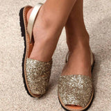 Elegant Avarca Sandals: Side view of elegant gold glitter Avarca sandals, showcasing the open-toe design and secure heel strap for a comfortable fit.