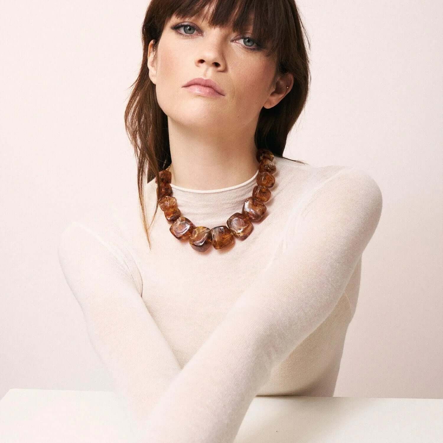 Model wearing the Big Organic Shaped Necklace in bold amber by Vanessa Baroni