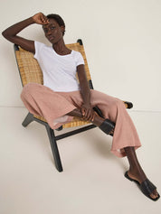 Model wearing Lanius Culotte in mocha paired with a white T-shirt and slides – casual sustainable summer look