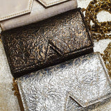 Aetalia Ary evening bag in bronze between the silver and gold versions, flap with the signature A cut-out