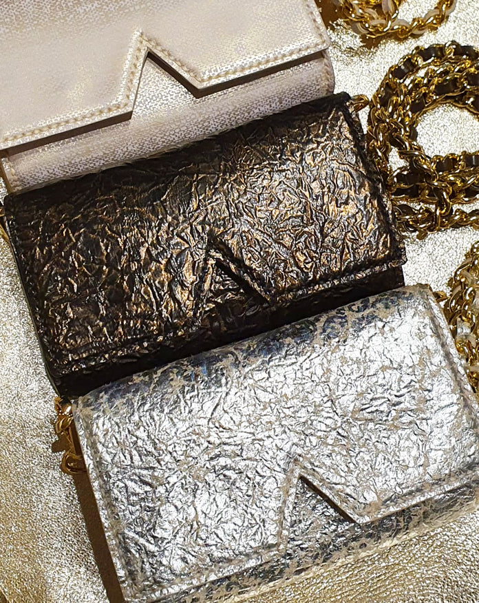 Aetalia Ary evening bag in bronze between the silver and gold versions, flap with the signature A cut-out