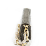 Aetalia Ary evening bag in olive crocodile print, open flap showing the snap closure and Aetalia logo plate