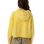 Rear view of the Amy yellow zip-up hooded jacket on a model, highlighting its casual loose drape and premium stitched finishes.