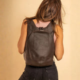 Model wearing the ARSAYO Mela backpack in dark brown AppleSkin