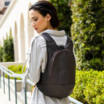 Model wearing the ARSAYO Mela backpack in dark brown AppleSkin